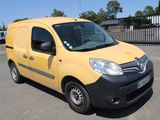 a yellow van that is parked in a parking lot