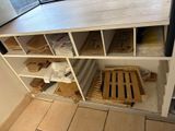 a shelf with a lot of boxes on it in a room