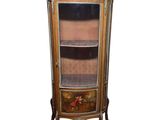 an image of a corner cabinet with a glass door and drawers