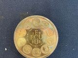 a gold coin with a picture on it on a blue surface