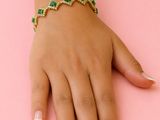 a close up of a person ' s hand with a bracelet on it