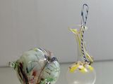 two glass vases that are sitting on a table