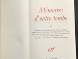 an open book with red writing on it sitting on a table