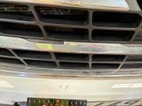 a close up of a car ' s grille with a sticker on it