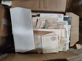 a cardboard box full of mail sitting on the floor
