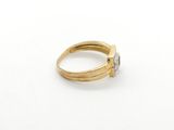 a close up of a gold ring with a diamond on it