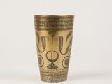 an old brass cup with a decorative design on it