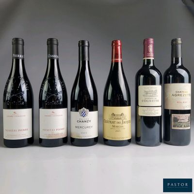 several bottles of wine are lined up in a row on a table