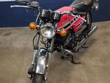 a red and black motorcycle parked in a garage