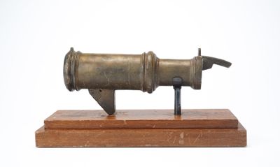 a small metal object on a wooden stand