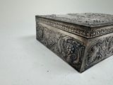 a silver box that is sitting on a white surface
