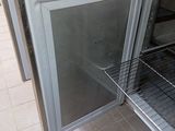 a silver oven with a rack in the middle of it
