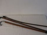 two canes and a pair of scissors on a table