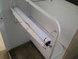 a roll of toilet paper hanging from a cabinet
