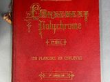 an old red book with gold lettering on it sitting on a table