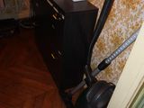 a vacuum that is sitting on the floor next to a cabinet