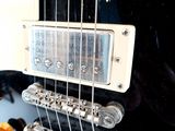 a close up of an electric guitar with strings and knobs