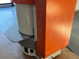 an orange and white machine sitting on top of a wooden table