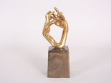 sculpture of a hand on a marble block on a white background
