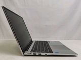 a laptop that is sitting on a white surface