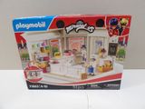 a box of playmobil with a doll house inside of it