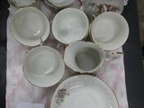 a table with a bunch of cups and saucers on it