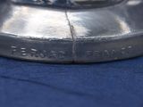 a close up of a silver object on a blue cloth