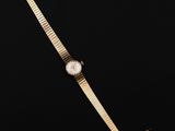 a gold watch on a black background with a black background