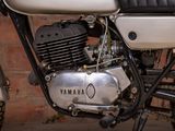a motorcycle that is parked next to a brick wall