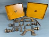 a lot of old brass items in a yellow case