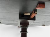 a close up of a wooden table with a metal base