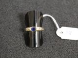 a silver ring with a blue stone on top of it