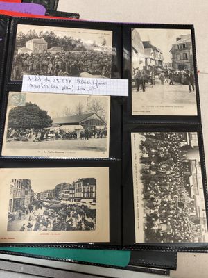 several old black and white photos of people and buildings in a book