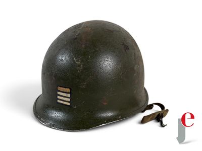 an old helmet is sitting on a white surface with a cord attached to it