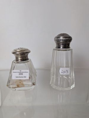 two salt and pepper shakers sitting on a table