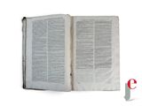 an open book with a picture of a red cross on top of it