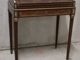 a small desk with a drawer on top of it