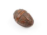 an old wooden bead with carvings on it on a white surface