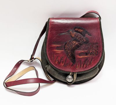 a brown and black purse with a duck on it