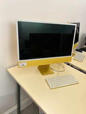 a desk with a computer and a keyboard on it
