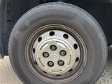 a close up of a flat tire on a blue truck