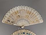 a white fan that is hanging on the wall