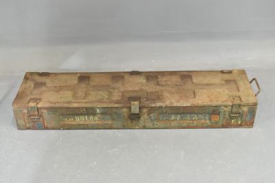 an old metal tool box sitting on top of a white surface