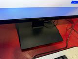 a computer monitor and keyboard on a desk