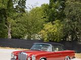 a red car that is parked on the side of the road