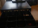 a computer on a desk with a drawer of jewelry