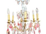 a close up of a chandelier with pink and white flowers