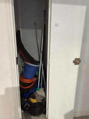 a small closet with a lot of cleaning supplies in it