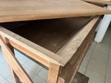 a wooden table with a drawer on top of it
