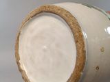 a close up of a vase on a table